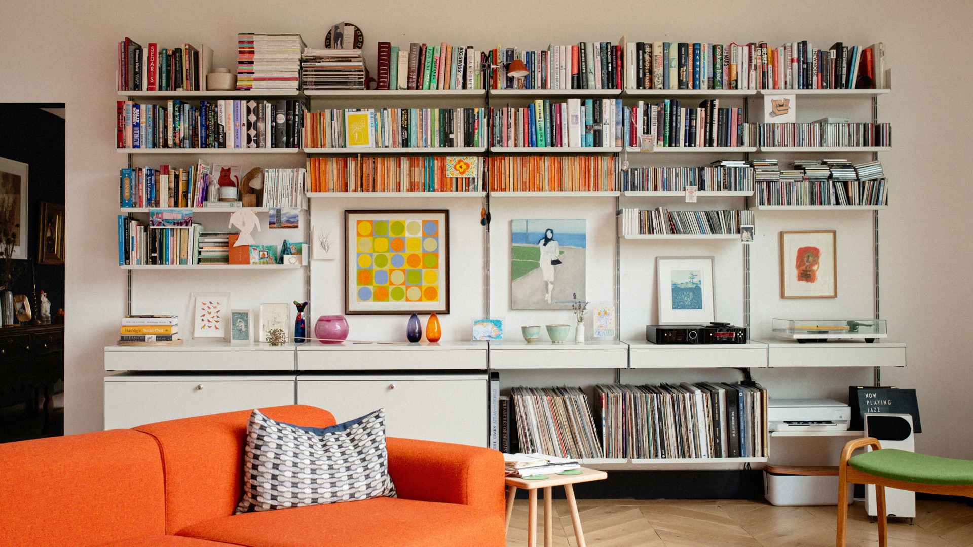 Books, records, art, and story material arranged on a shelving system